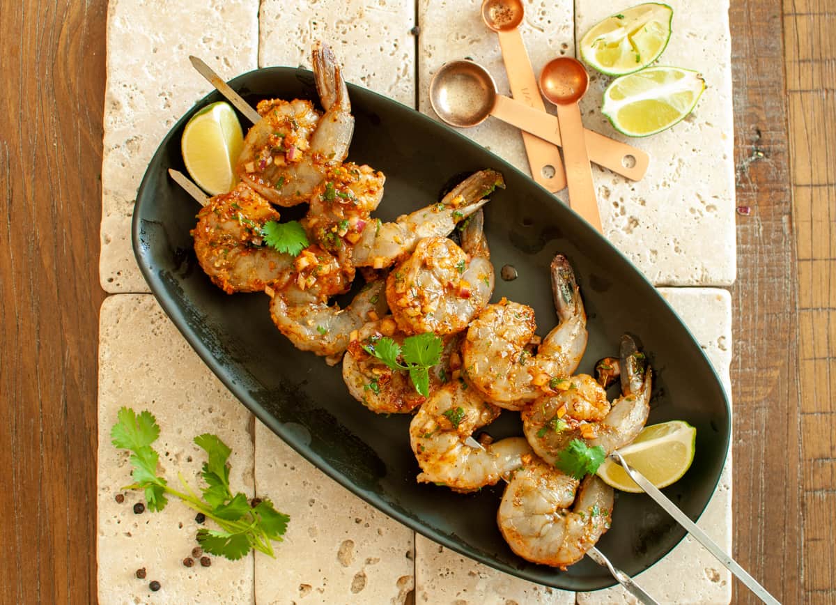 marinaded shrimp on a metal skewer ready to be grilled