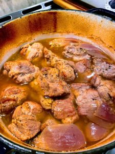 Pork shoulder simmering in a dutch oven
