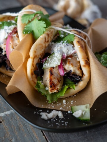 Yogurt marinaded greek chicken served in a pita tied with string