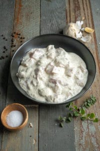 chicken marinading in a bowl