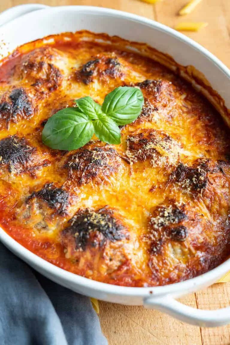 Baked Italian Meatballs garnished with fresh basil