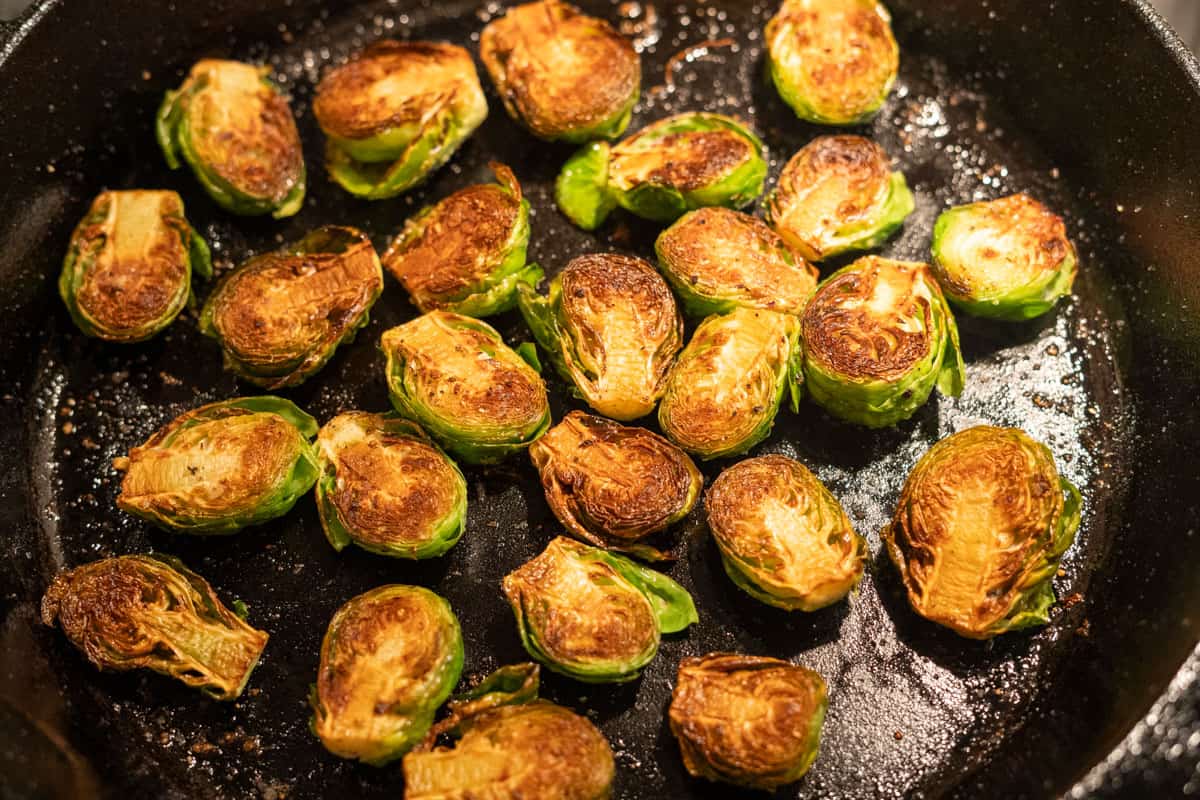 Brussel sprouts in a cast iron pan, crispy and browned