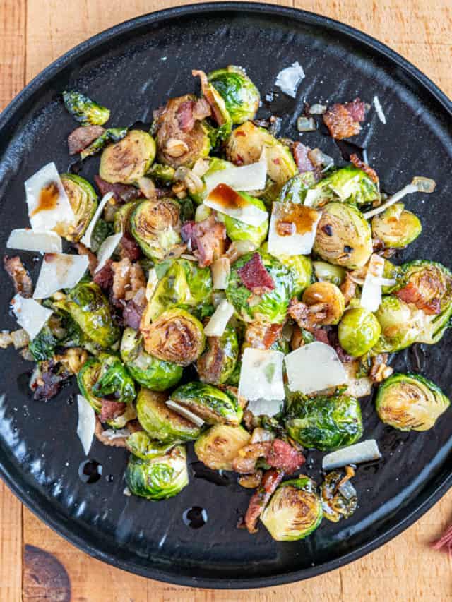 Smoked Brussels Plated with shaved parmesan cheese, and bacon lardons