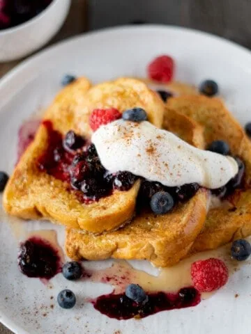 Brioche french toast with whipped cream and blueberry sauce