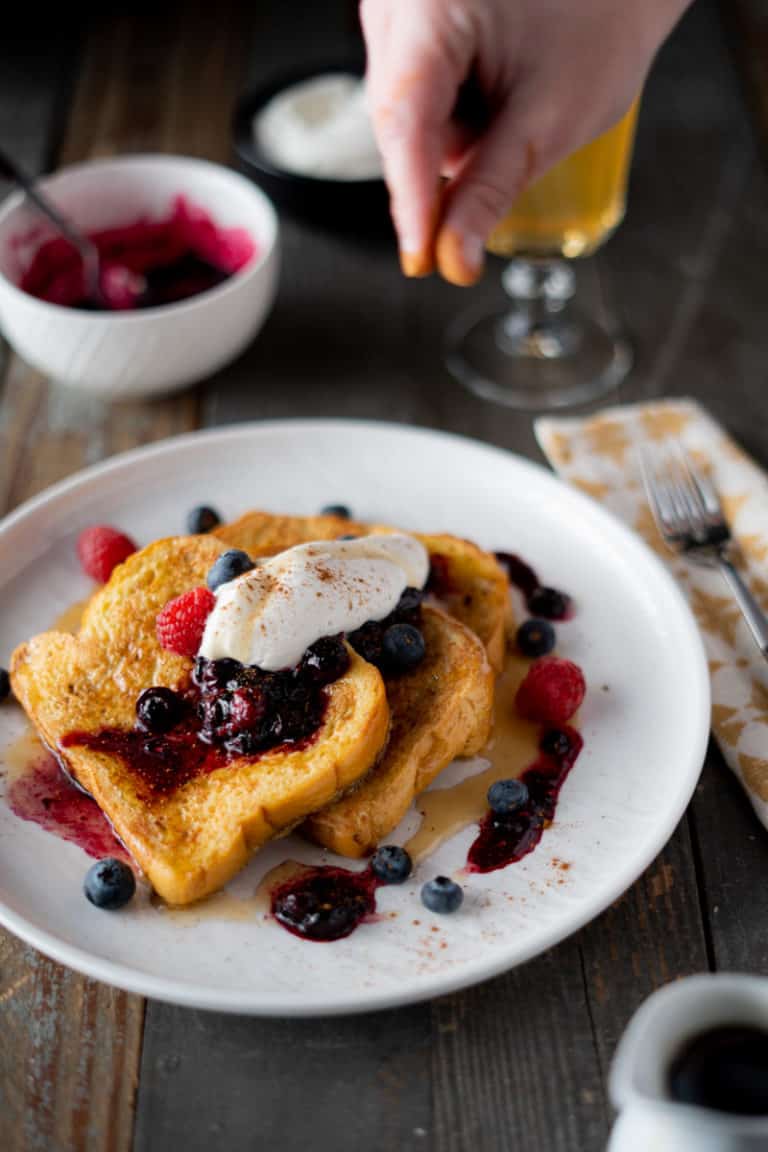 Brioche French Toast with whipped cream and a cinnamon sprinkle