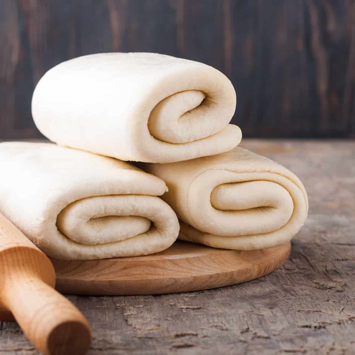 three batches of croissant dough