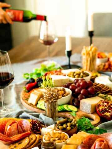 three charcuterie boards on a dining table