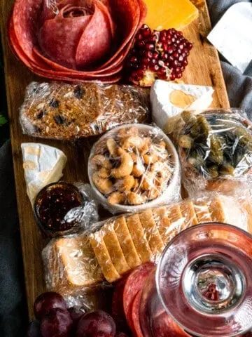 charcuterie board with components individually wrapped