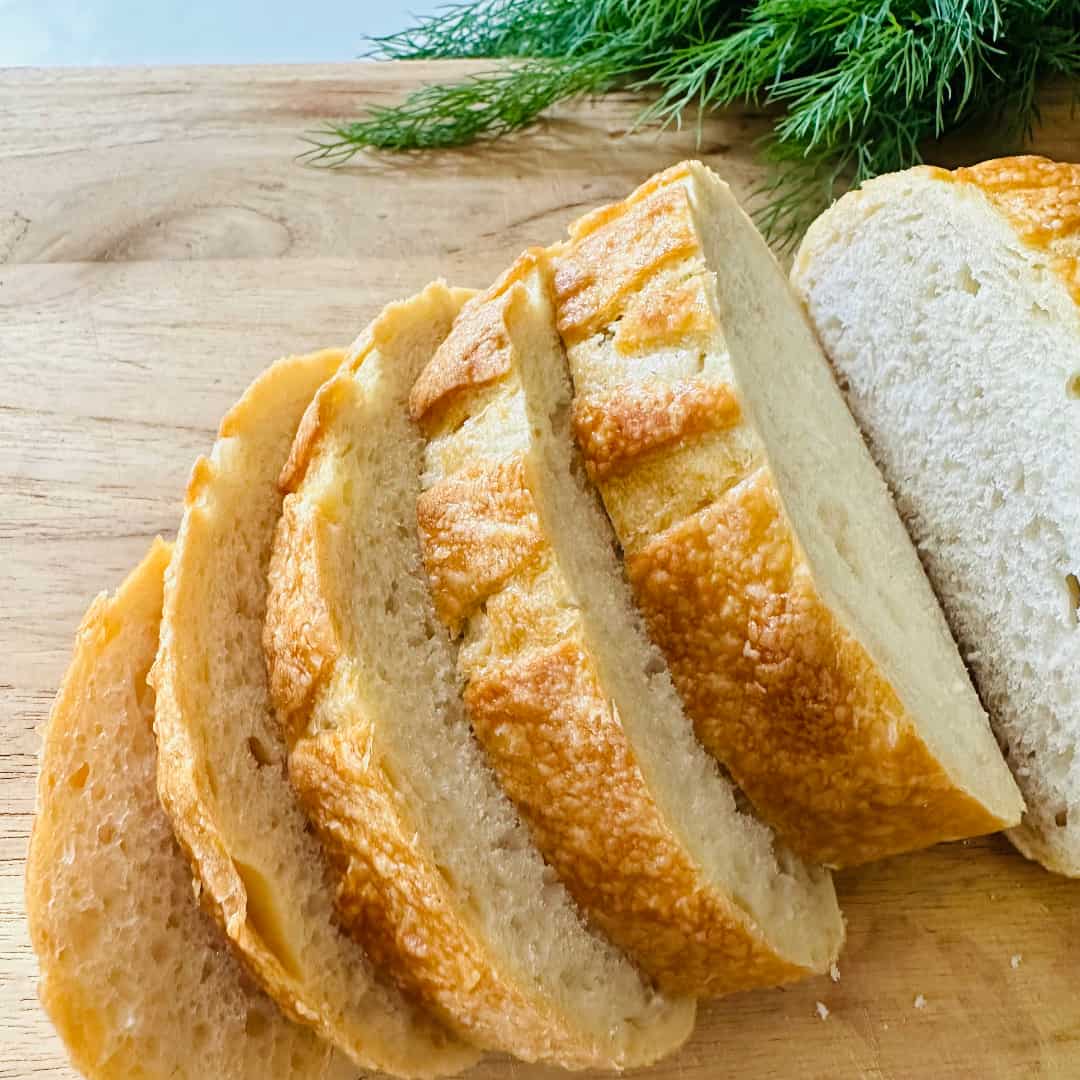 Sliced sourdough bread on a wooden cutting board