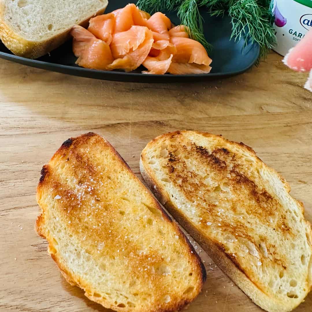 Seasoning toasted sourdough with kosher salt and black pepper