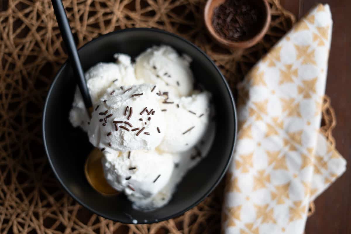 Scoops of mexican vanilla ice cream in a bowl with chocolate sprinkles