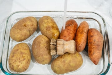 potatoes being scrubbed in the sink