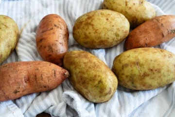 potatoes sitting on a dish towel