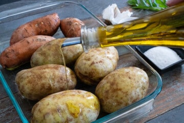 Drizzling olive oil on potatoes
