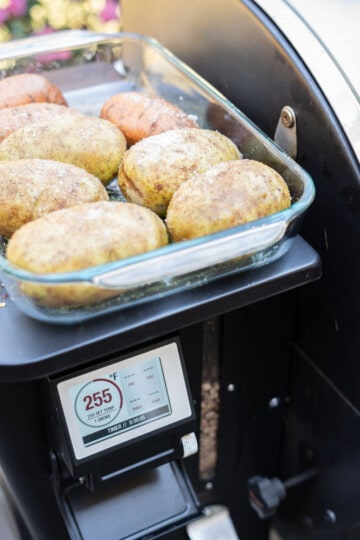 Prepped potatoes, in a glass dish by the smoker, set to 255 degrees