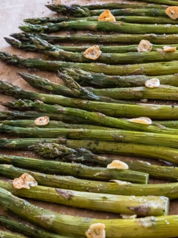 Fresh roasted asparagus topped with garlic slices and drizzled with hot honey.
