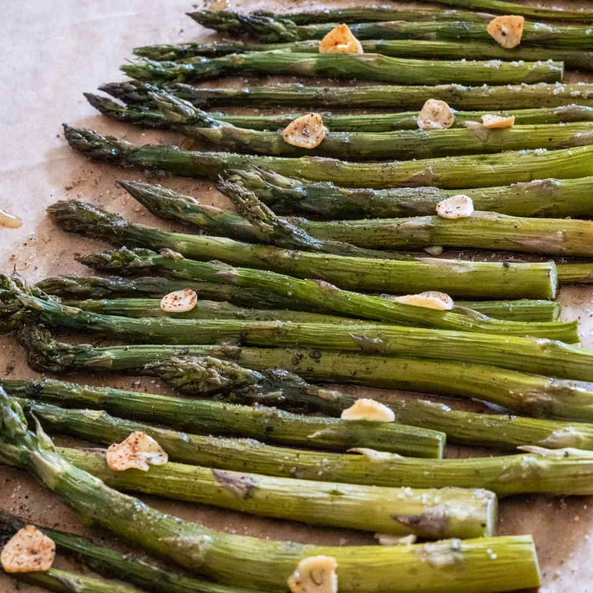 Fresh roasted asparagus topped with garlic slices and drizzled with hot honey.