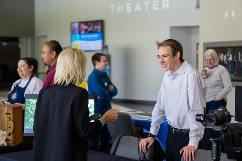 Dillon Callaway talking to professor at CKEC entrepreneur fair