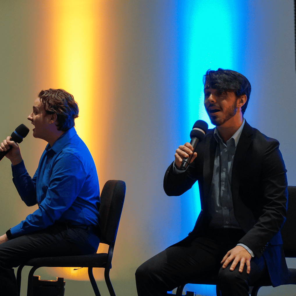 Two Tabor students sing on stage during Dinner Theatre Showcase