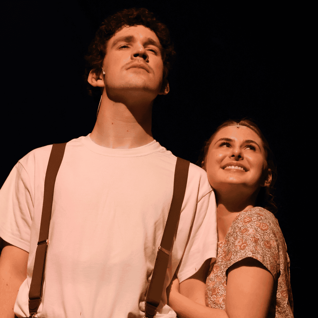 Two students stand on stage while acting Bright Star 