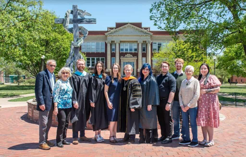 A picture of the David and Karen Janzen family in front of the Centennial Plaza on Commencement Day