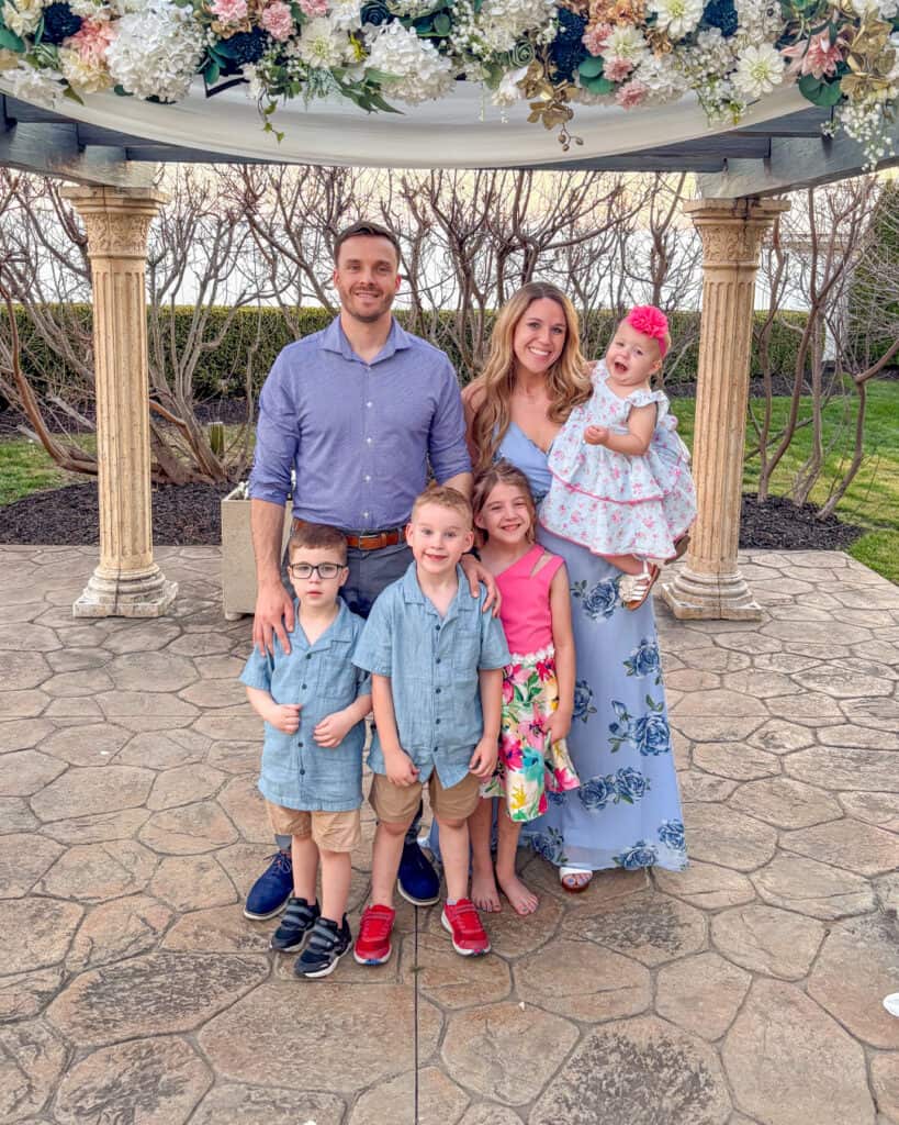 Andrew and Kelsey Wiens and their four children pose for a picture on an outdoor stone stage