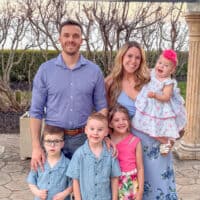 Andrew and Kelsey Wiens and their four children pose for a picture on an outdoor stone stage