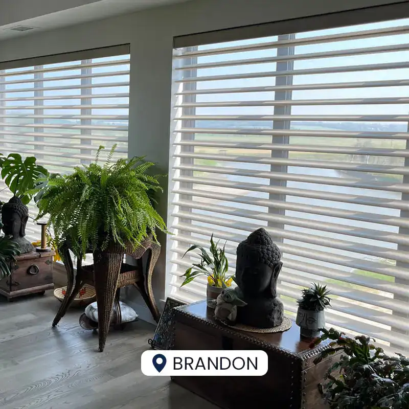 Bright living room with expansive windows and decorative Buddha statues.