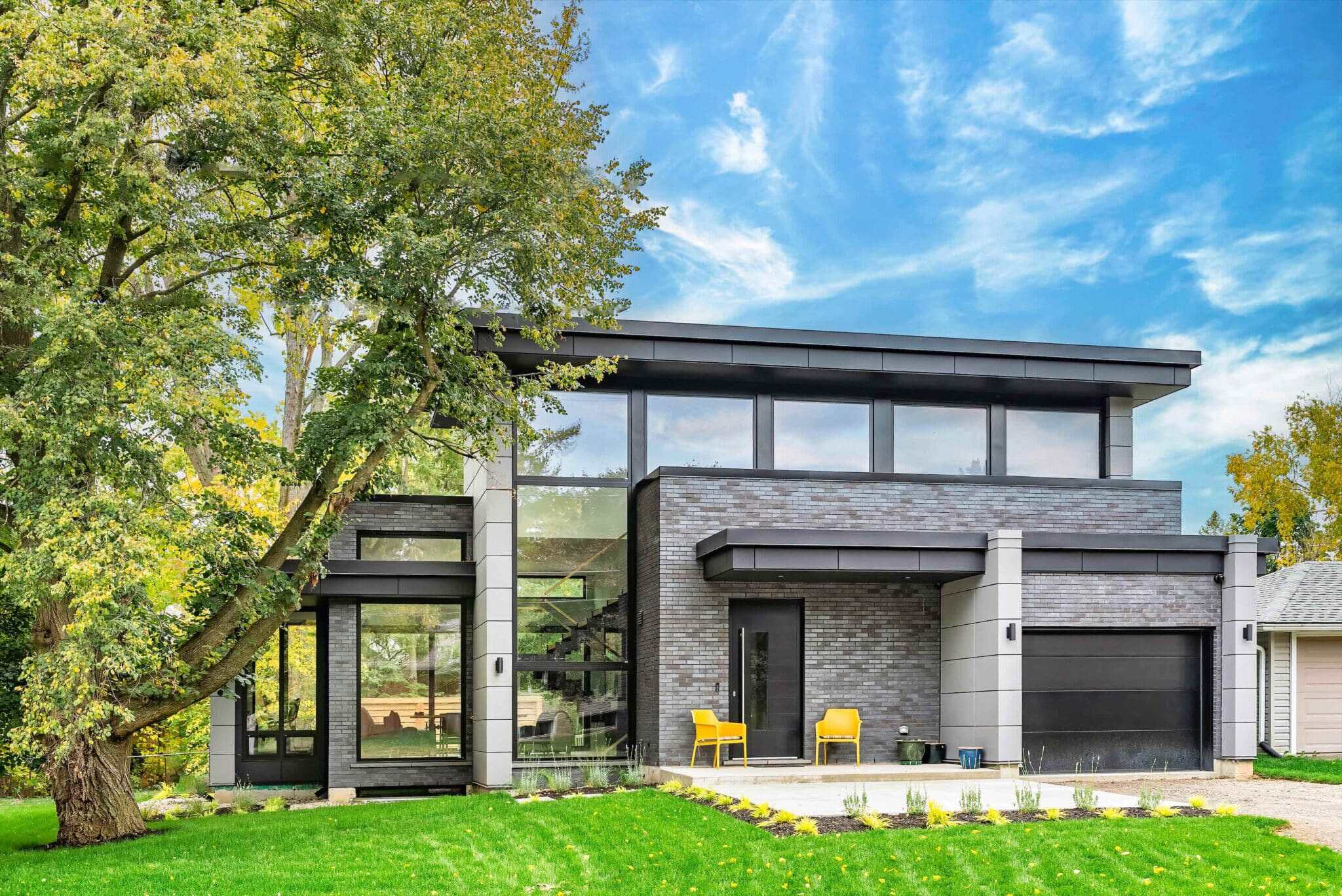 Modern contemporary house with large windows, flat roof, and sleek design, showcasing innovative bui.
