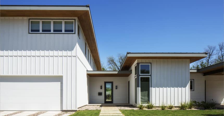 Contemporary white house with large windows and modern design elements.
