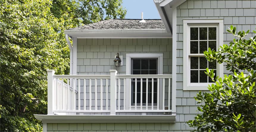 Tamar Building Products - Durable white balcony railing on a charming residential home.