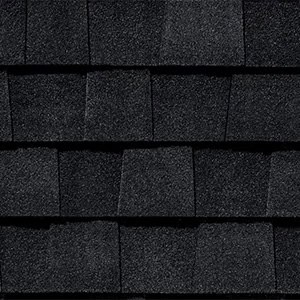 Black asphalt shingles stacked for roofing.