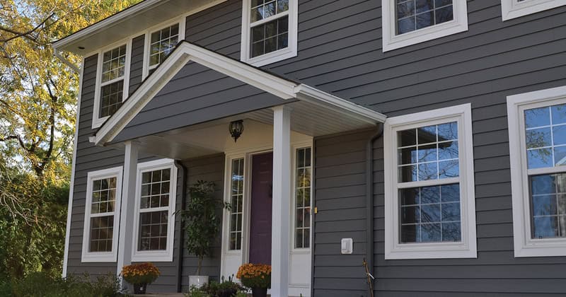 Grey siding and white trim on a contemporary residential house in Ontario, Canada.