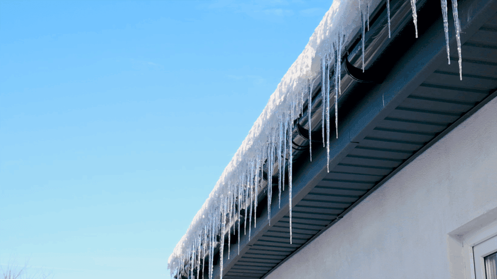 Icicle-decorated roof edge showcasing durable building materials from Tamar Building Products.