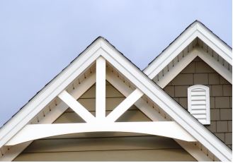 Gable roof with decorative trusses on a residential home.