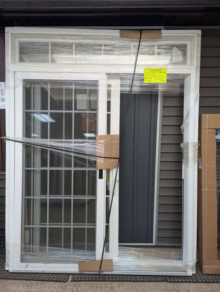 New white vinyl window with grid pattern, ready for installation.