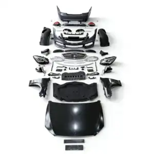 Disassembled car body parts including hood, bumper, and headlights for auto repair or restoration.
