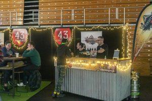 Foam pouring at Taranaki Beer Festival 43 Brewing stand to enjoy craft beers.