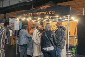 Craft beer tent at Taranaki Beer Festival with Roots Brewing Co. showcasing local craft beers in New Zealand.