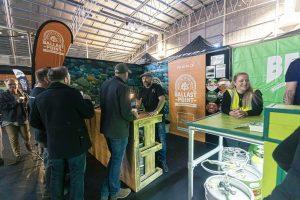 Craft beer stall at Taranaki Beer Festival showcasing Ballast Point Brewing Company products in an indoor event setting.