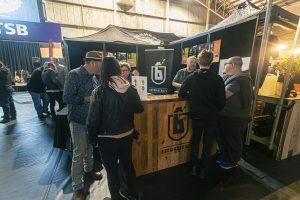 Brewery booth at Taranaki Beer Festival showcasing craft beers and local breweries in New Zealand.