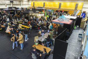 Vibrant Taranaki Beer Festival indoor event showcasing craft beer stalls and festival attendees.