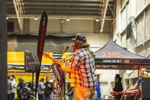 Vibrant live music performance at the Taranaki Beer Festival in an indoor venue with diverse attendees enjoying the event.