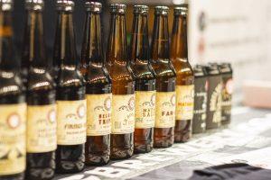 Assorted craft beer bottles at Taranaki Beer Festival showcasing local and international brews.