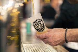 Craft beer being poured at Taranaki Beer Festival, showcasing local brewing talent.