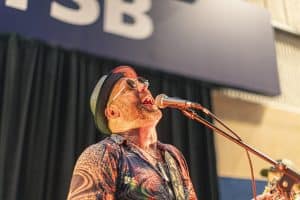 Colourful performer singing at Taranaki Beer Festival, showcasing live New Zealand beer festival entertainment.