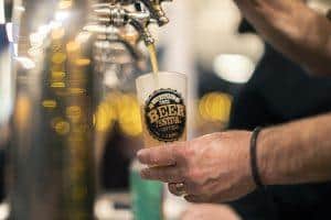 Refreshing craft beer being poured at the Taranaki Beer Festival, showcasing local brews and vibrant festival atmosphere.