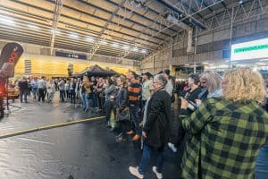Crowd enjoying Taranaki Beer Festival indoor at TSB Arena with beer stalls and live entertainment.