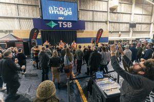 Live music performance at Taranaki Beer Festival with crowd of attendees enjoying craft beers and entertainment in New Zealand.