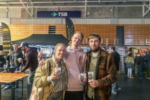 Vivid scene of attendees enjoying Taranaki Beer Festival with craft beers and lively atmosphere.